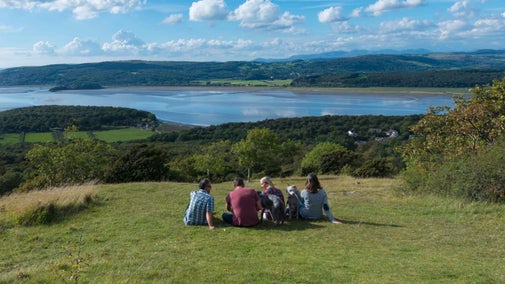 Visitors enjoying the views over the River Kent Estuary at Arnside and Silverdale, Cumbria.